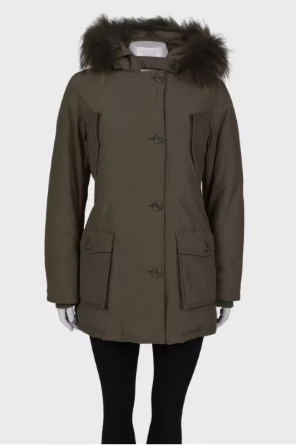 Green parka with fur on the hood with a tag