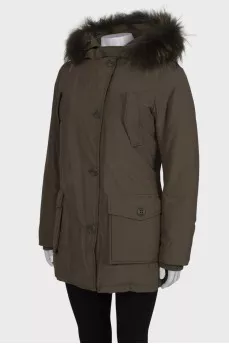 Green parka with fur on the hood with a tag