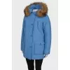 Blue parka with fur on the hood with a tag