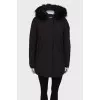 Black parka with fur on the hood with a tag