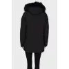 Black parka with fur on the hood with a tag
