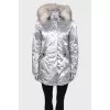 Silver parka with fur on the hood with a tag