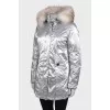 Silver parka with fur on the hood with a tag