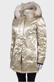 Golden parka with fur on the hood with a tag