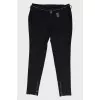 Black trousers with metal belt