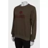 Dark green sweatshirt with brand logo