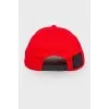 Red cap with embroidery, with a tag