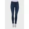 Navy blue jeans with a zip at the bottom