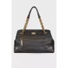Black leather bag with golden hardware