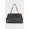 Black leather bag with golden hardware