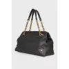 Black leather bag with golden hardware