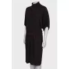 Dress with a high collar, on the belt