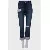 Ripped effect jeans with tag
