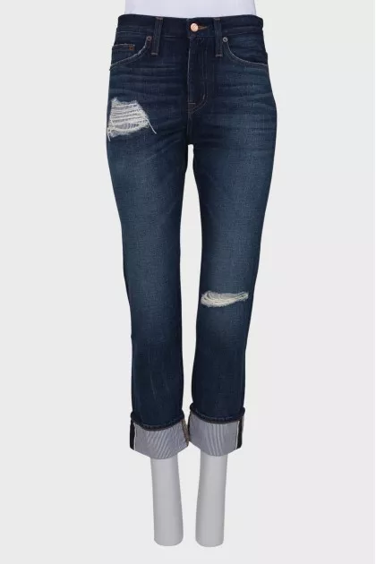 Ripped effect jeans with tag