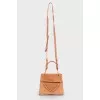 Perforated suede bag