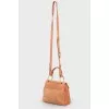 Perforated suede bag
