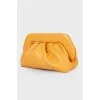 Draped leather clutch
