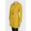 Yellow trench coat at the waist