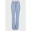 Light blue jeans with slits at the waist