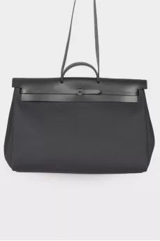 Travel bag with leather flap