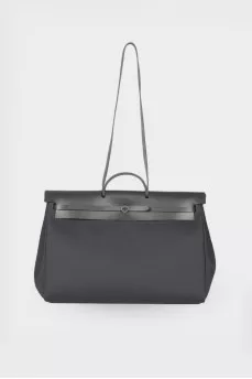 Travel bag with leather flap