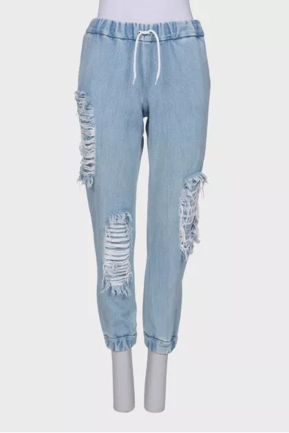 Ripped-effect elasticated jeans
