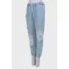Ripped-effect elasticated jeans