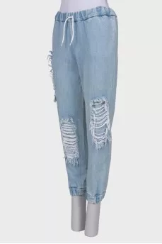 Ripped-effect elasticated jeans