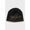Black hat with golden lettering