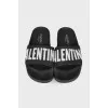 Black slippers with brand logo