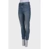 Light blue jeans with distressed patch