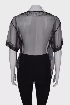 Translucent blouse with rhinestones with a tag