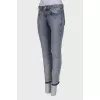Light blue jeans with embellished belt