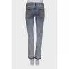 Light blue jeans with embellished belt