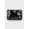 Lacquered black zip clutch