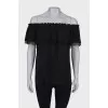 Black top with a frill on the chest