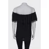 Black top with a frill on the chest