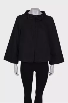 Jacket decorated with a bow
