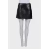 Lacquered black skirt with embossing
