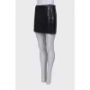 Lacquered black skirt with embossing