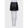 Lacquered black skirt with embossing