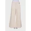 Beige palazzo trousers with tag