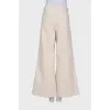 Beige palazzo trousers with tag