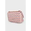 Textile bag with medallions on the strap