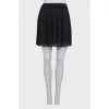 Pleated mini skirt with tag