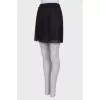 Pleated mini skirt with tag
