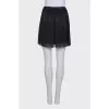 Pleated mini skirt with tag