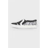 Black and white lace slip-ons