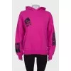 Pink sweatshirt with print and tag
