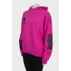 Pink sweatshirt with print and tag